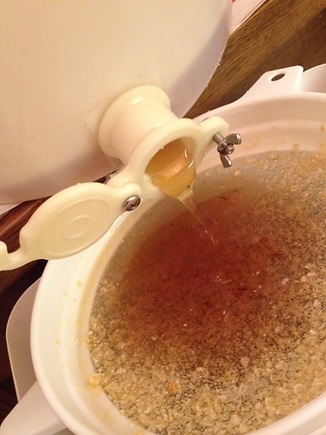 Honey filter: Honey draining from the extractor to the sieve and bucket.