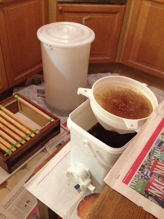 Frames, extractor and filter: See the lovely honey in the bucket